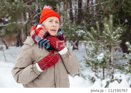 Mature woman in warm clothes having sore throat 112580767