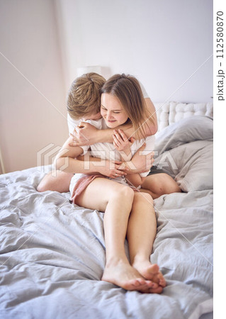 tender embrace of young man and woman at home 112580870
