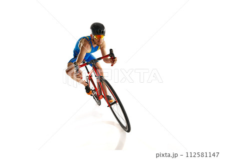 Dynamic image of concentrated man, athlete, cyclist on motion riding on bike isolated on white studio background 112581147
