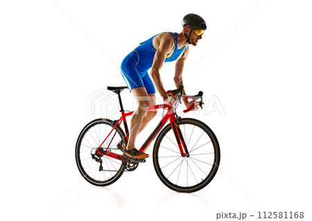 Athletic young man, cyclist in uniform, helmet and goggles in motion, riding bike isolated on white studio background 112581168