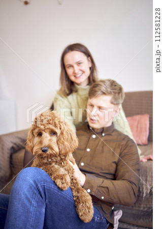 cockapoo in the hands of parents 112581228