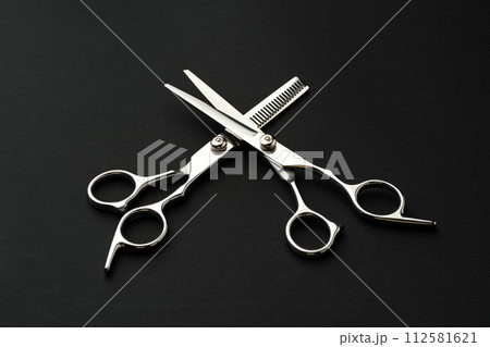 Hairdressing scissors on black background studio shot Hairdressing scissors on black background studio shot 112581621
