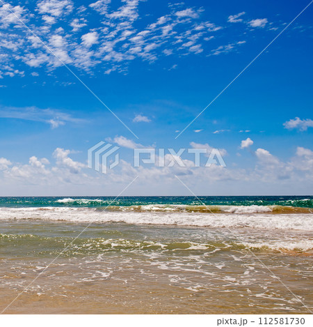 Scenic beach and sky with beautiful cumulus clouds. 112581730