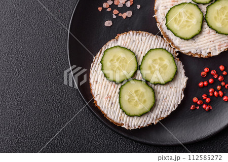 Delicious vegetarian sandwich with grilled toast, cream cheese, cucumbers and seeds Delicious vegetarian sandwich with grilled toast, cream cheese, cucumbers and seeds 112585272