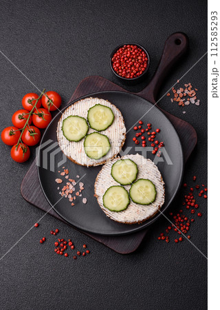 Delicious vegetarian sandwich with grilled toast, cream cheese, cucumbers and seeds Delicious vegetarian sandwich with grilled toast, cream cheese, cucumbers and seeds 112585293