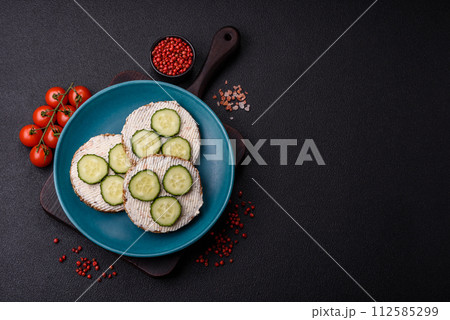 Delicious vegetarian sandwich with grilled toast, cream cheese, cucumbers and seeds Delicious vegetarian sandwich with grilled toast, cream cheese, cucumbers and seeds 112585299