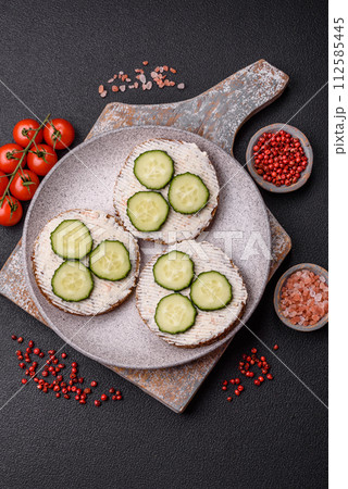 Delicious vegetarian sandwich with grilled toast, cream cheese, cucumbers and seeds Delicious vegetarian sandwich with grilled toast, cream cheese, cucumbers and seeds 112585445