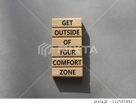 Get outside of your comfort zone symbol. Concept words Get outside of your comfort zone on wooden blocks. Beautiful grey background. Business concept. Copy space. 112585892