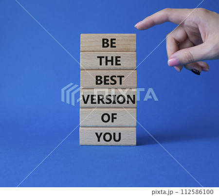 Be the best version of you symbol. Concept words Be the best version of you on wooden blocks. Businessman hand. Beautiful blue background. Business concept. Copy space. 112586100