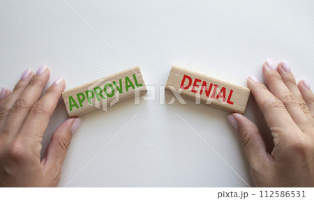 Approval or Denial symbol. Concept word Approval or Denial on wooden blocks. Businessman hand. Beautiful white background. Business and Approval or Denial concept. Copy space Approval or Denial symbol. Concept word Approval or Denial on wooden blocks. Businessman hand. Beautiful white background. Business and Approval or Denial concept. Copy space 112586531