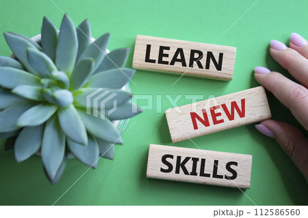 Learn new skills symbol. Concept words Learn new skills on wooden blocks. Beautiful green background with succulent plant. Businessman hand. Business and Learn new skills concept. Copy space. Learn new skills symbol. Concept words Learn new skills on wooden blocks. Beautiful green background with succulent plant. Businessman hand. Business and Learn new skills concept. Copy space. 112586560
