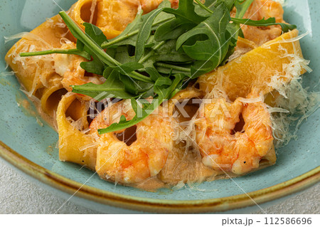 Portion of pappardelle pasta with shrimp 112586696