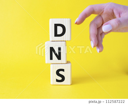 DNS -Domain Name Server - Consumer Price Index symbol. Concept word DNS on wooden cubes. Businessman hand. Beautiful yellow background. Business and DNS concept. Copy space. DNS -Domain Name Server - Consumer Price Index symbol. Concept word DNS on wooden cubes. Businessman hand. Beautiful yellow background. Business and DNS concept. Copy space. 112587222