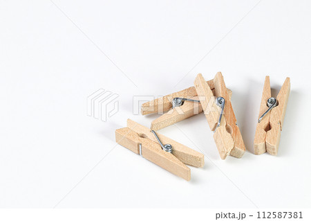 Mini wooden clothespin collection isolated on white background. Clothespins in different positions for household use or decorated. Mini wooden clothespin collection isolated on white background. Clothespins in different positions for household use or decorated. 112587381