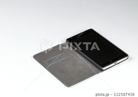 Mobile phone or smart phone in leather case open on white background Mobile phone or smart phone in leather case open on white background 112587416