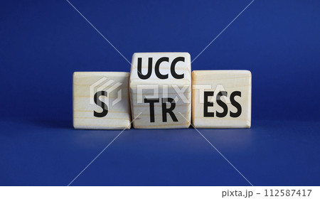 Success vs Stress symbol. Wooden cubes with words Stress and Success. Beautiful deep blue background. Business concept and Success vs Stress. Copy space 112587417