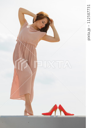 Woman dancing wearing long light pink dress 112587731