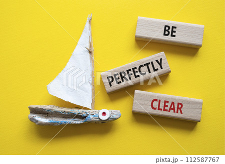 Be perfectly clear symbol. Concept words Be perfectly clear on wooden blocks. Beautiful yellow background with boat. Business and Be perfectly clear concept. Copy space 112587767