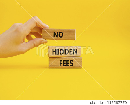 No hidden fees symbol. Concept word No hidden fees on wooden blocks. Businessman hand. Beautiful yellow background. Business and No hidden fees concept. Copy space 112587770