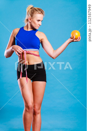 woman fit girl with measure tape and grapefruit woman fit girl with measure tape and grapefruit 112587949