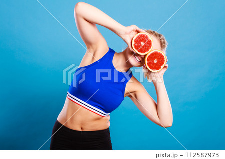 Woman holding grapefruit citrus fruit in hands 112587973