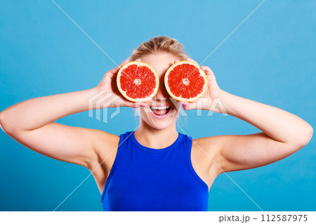 Woman holding grapefruit citrus fruit in hands 112587975