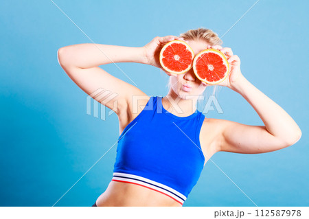 Woman holding grapefruit citrus fruit in hands 112587978