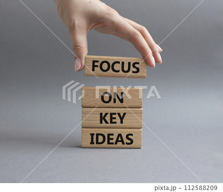 Focus on Key Ideas symbol. Concept words Focus on Key Ideas on wooden blocks. Beautiful grey background. Businessman hand. Business and Focus on Key Ideas concept. Copy space Focus on Key Ideas symbol. Concept words Focus on Key Ideas on wooden blocks. Beautiful grey background. Businessman hand. Business and Focus on Key Ideas concept. Copy space 112588209