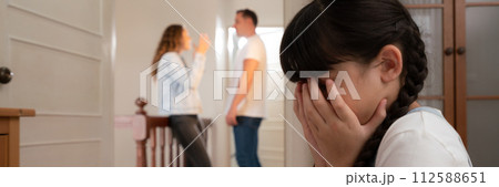 Stressed and unhappy young girl hide from domestic violence at home. Synchronos Stressed and unhappy young girl hide from domestic violence at home. Synchronos 112588651
