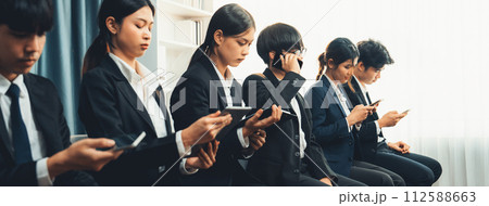 Job candidates in formal suits line up for interview at HR agency. Job candidates in formal suits line up for interview at HR agency. 112588663