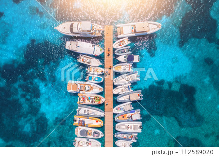 Aerial view of boats and luxure yachts in dock in summer day 112589020