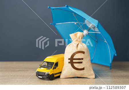 Delivery van and euro money bag under an umbrella. Cargo and parcel insurance. Warranty obligations. Logistics security. 112589307