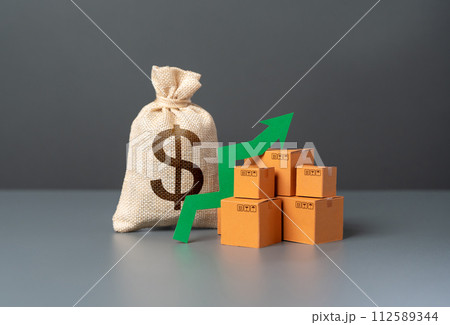 Boxes with goods and a green arrow up next to a dollar money bag. Increasing the economy and profits from the sale. Trade surplus. Demand for goods, growth in prosperity. Import and export. Boxes with goods and a green arrow up next to a dollar money bag. Increasing the economy and profits from the sale. Trade surplus. Demand for goods, growth in prosperity. Import and export. 112589344