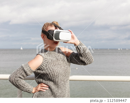 Woman wearing VR outside Woman wearing VR outside 112589447