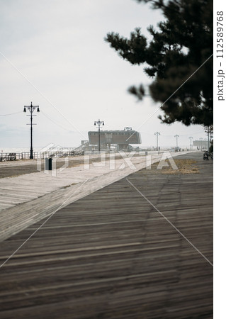 Desolate Boardwalk Leading to a Distant Building in New York 112589768