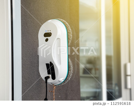Vacuum cleaner washing windows. Home appliance and technology concept 112591618