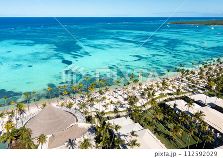 Tropical beach with resorts, palm trees and caribbean sea. Dominican Republic. Aerial view Tropical beach with resorts, palm trees and caribbean sea. Dominican Republic. Aerial view 112592029