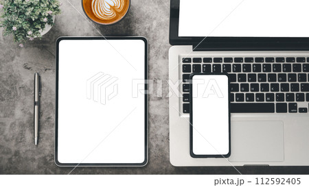 Tablet and smart phone with blank screen display on office desk workplace. Top view flat lay Tablet and smart phone with blank screen display on office desk workplace. Top view flat lay 112592405