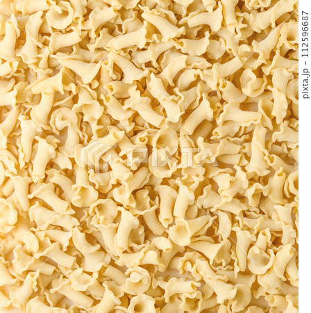 Uncooked Italian pasta Campanelle background. Gigli Pasta top view. High quality photo. 112596687