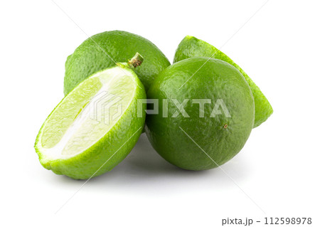 Whole and sliced limes, Sour green fruit isolated on a white background. Whole and sliced limes, Sour green fruit isolated on a white background. 112598978