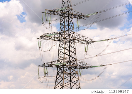 High voltage towers with sky background. Power line support with wires for electricity transmission. High voltage grid tower with wire cable at distribution station. Energy industry, energy saving High voltage towers with sky background. Power line support with wires for electricity transmission. High voltage grid tower with wire cable at distribution station. Energy industry, energy saving 112599147