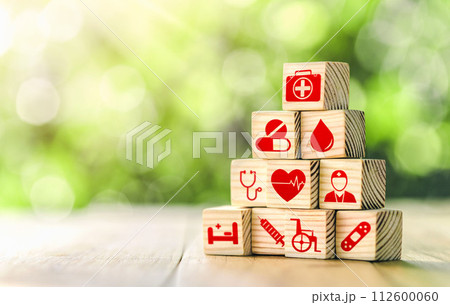 Lay out wooden blocks with icons of medical health. health insurance for your health concept. Healthcare medical business, medical technology equipment icon. Lay out wooden blocks with icons of medical health. health insurance for your health concept. Healthcare medical business, medical technology equipment icon. 112600060