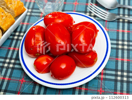 Plate with pickled tomatoes served for dinner on table Plate with pickled tomatoes served for dinner on table 112600313