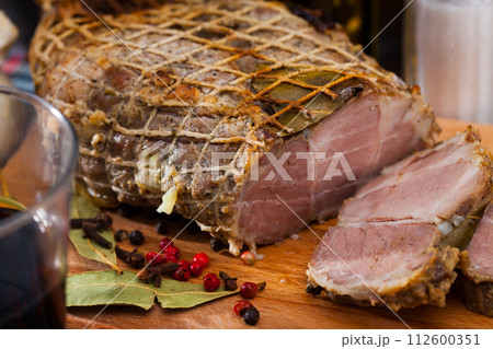 Appetizing pork ham with spices on a cutting board 112600351