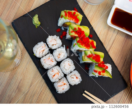 Popular Japanese dishes are rolls Uramaki and Hosomaki Popular Japanese dishes are rolls Uramaki and Hosomaki 112600456