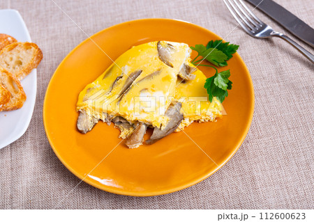 Portion of scrambled eggs with mushrooms served on table closeup 112600623