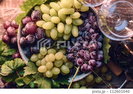 Grapes in a bowl on wooden table 112601040