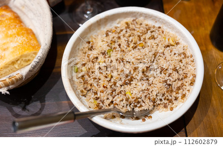Rice with lentils and onions served on plate 112602879