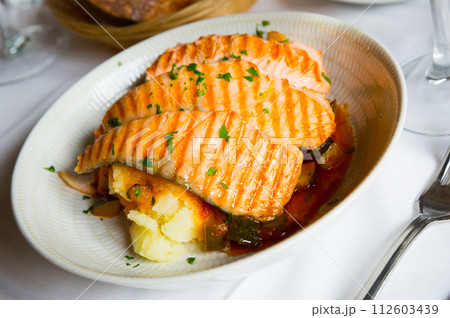 Salmon on the grill, marinated in sauce, dill, salt, pepper and a few drops of lemon Salmon on the grill, marinated in sauce, dill, salt, pepper and a few drops of lemon 112603439