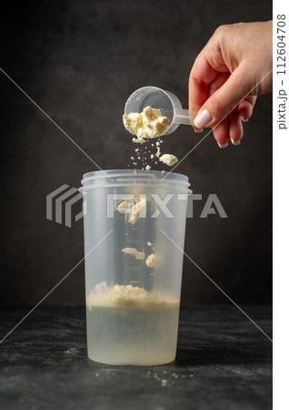 Vanilla white protein powder and shaker. Food supplement, nutrition  112604708